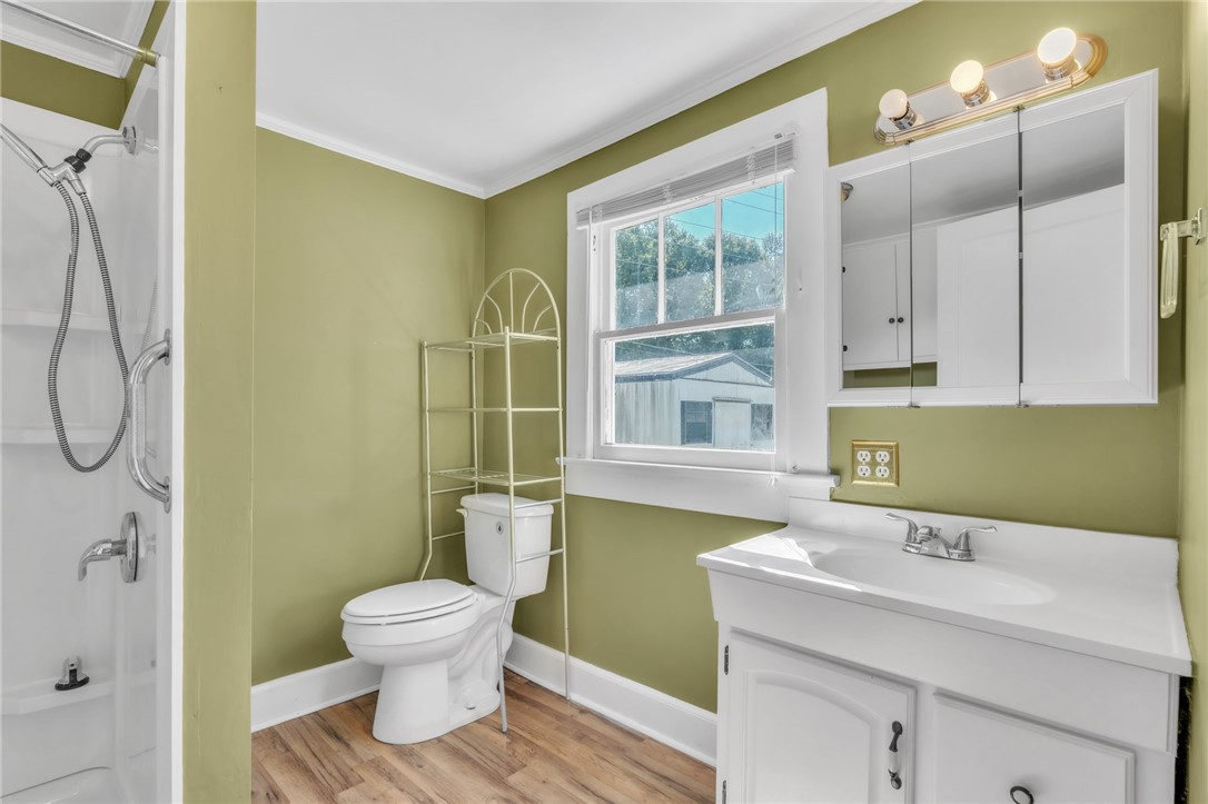 121 Ellison Street Belton, SC 29627 - Photo 17 of 30 This bright bathroom features a spacious shower, toilet, and vanity with ample storage.