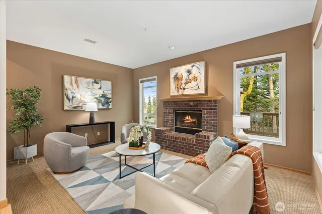 a living room with furniture a large window and a fireplace
