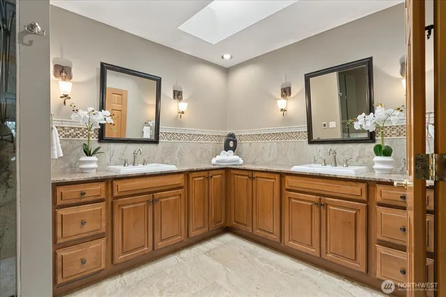 a spacious bathroom with double sink and a mirror