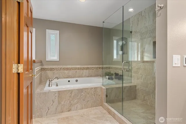 a bathroom with a bathtub and shower