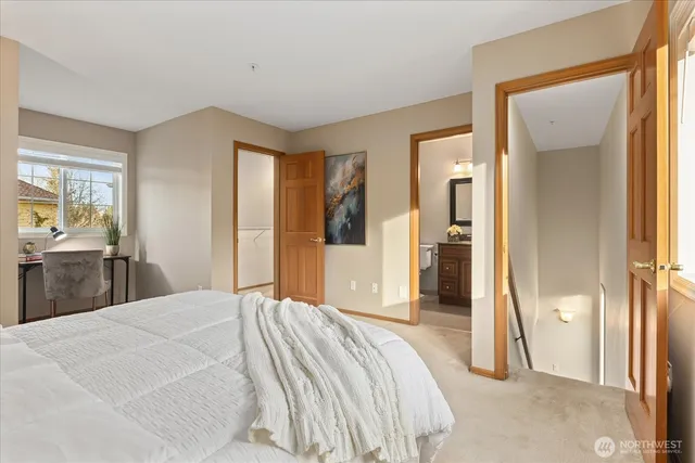 a bedroom with a bed and a large mirror