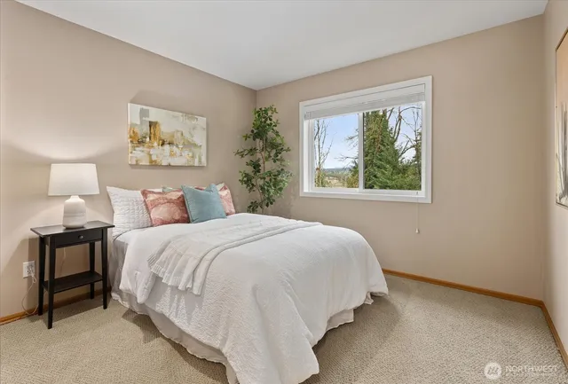 a bedroom with a bed and a painting on the wall