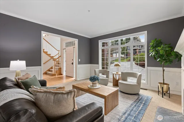 a living room with furniture and a potted plant
