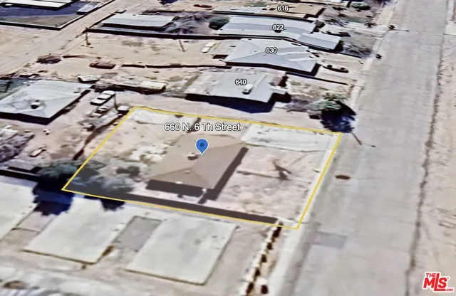 an empty room with a ceiling fan and window