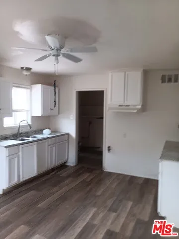 a kitchen with a sink and chandelier