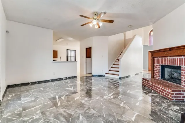 a view of an empty room with a fireplace