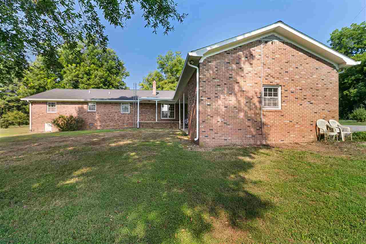 Large covered back porch and large storage/work room off the carport