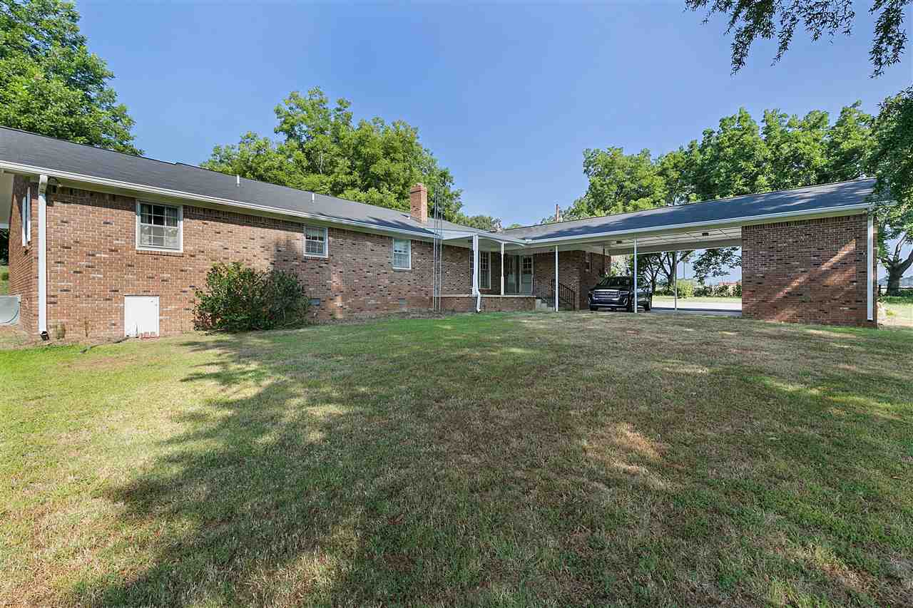 2 car carport. Room for a porch swing on that covered porch.
