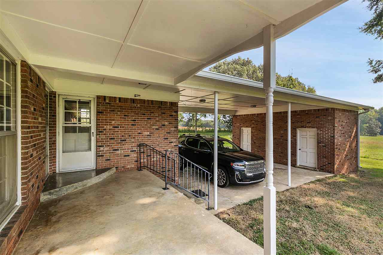 an entrance into the mudroom, laundry and half bath and an entry into the den. Also, double doors into storage room off 2 car carport.