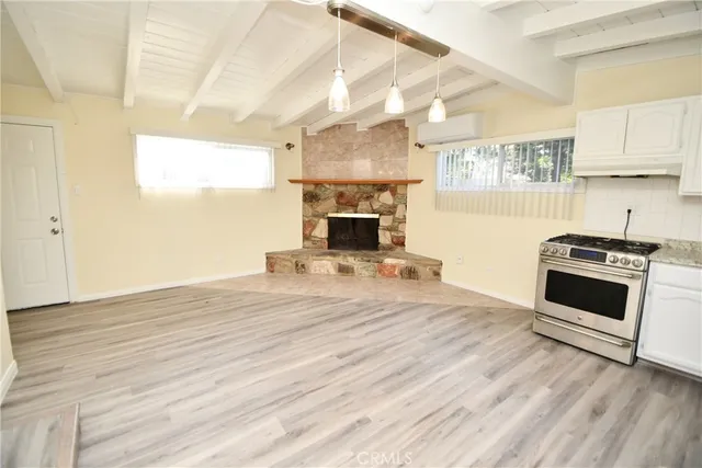 a room with a fireplace and cabinets