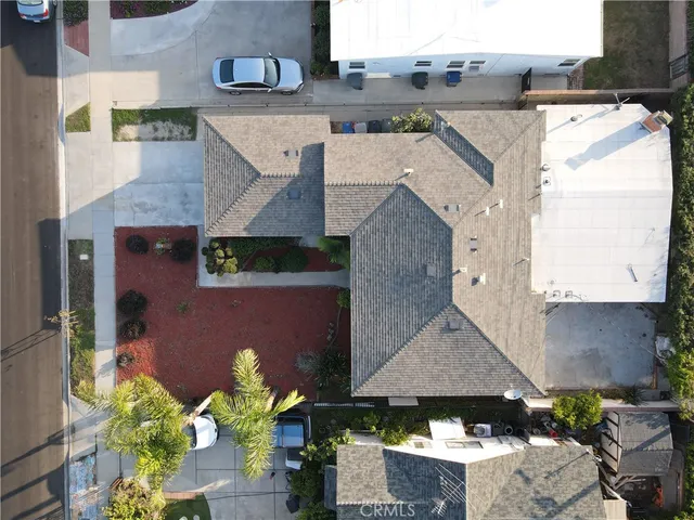 an aerial view of a house with a yard and a sitting area
