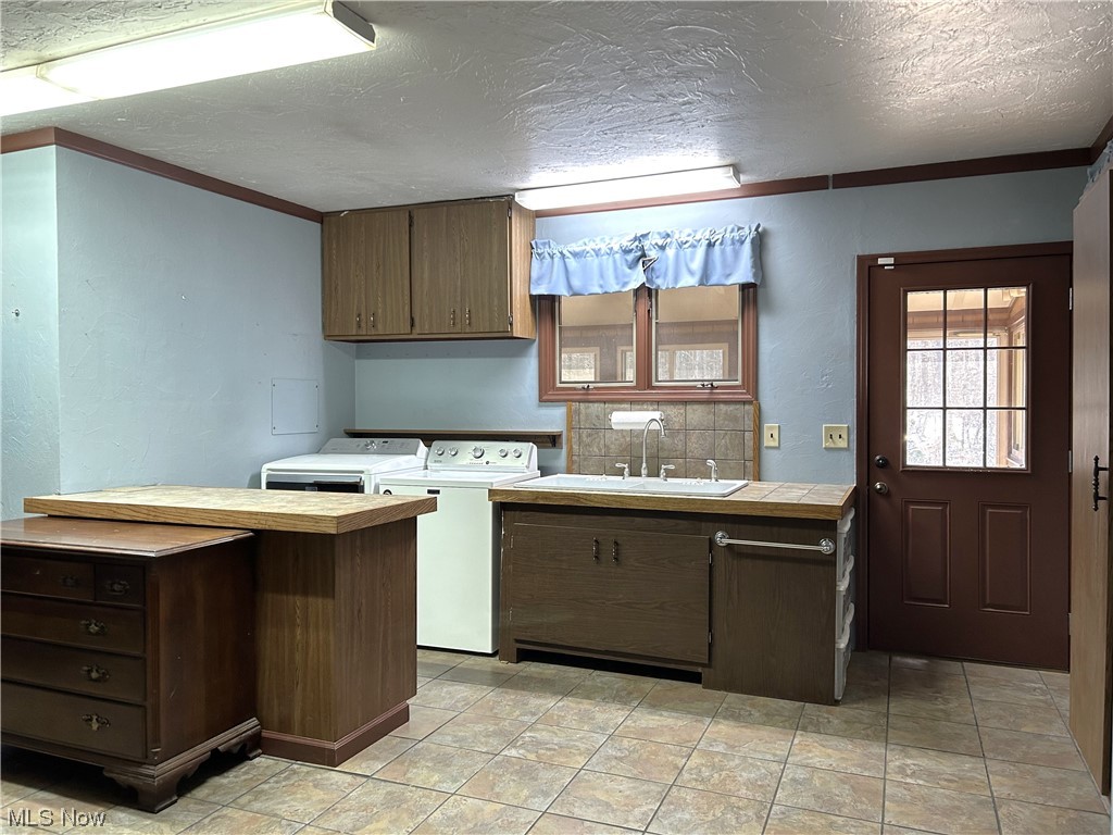 7855 Mulberry Road Chesterland, OH 44026 - Photo 21 of 46 Spacious Laundry Mud Room with washer and clothes dryer, laundry sink, and work cabinet.