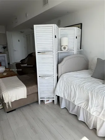 a bedroom with a bed and a night stand