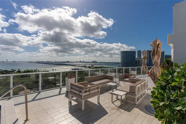 a terrace with outdoor seating and city view
