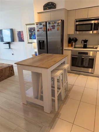 a kitchen with stainless steel appliances a stove a sink and a refrigerator