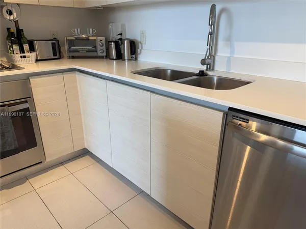 a kitchen with refrigerator and sink