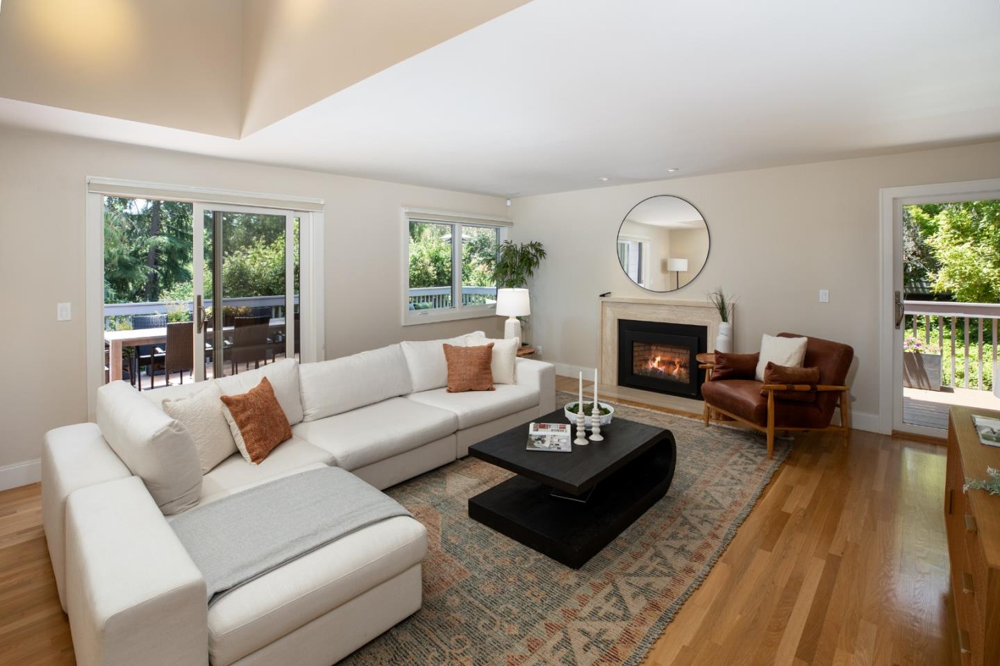 a living room with furniture a fireplace a large window and a fireplace