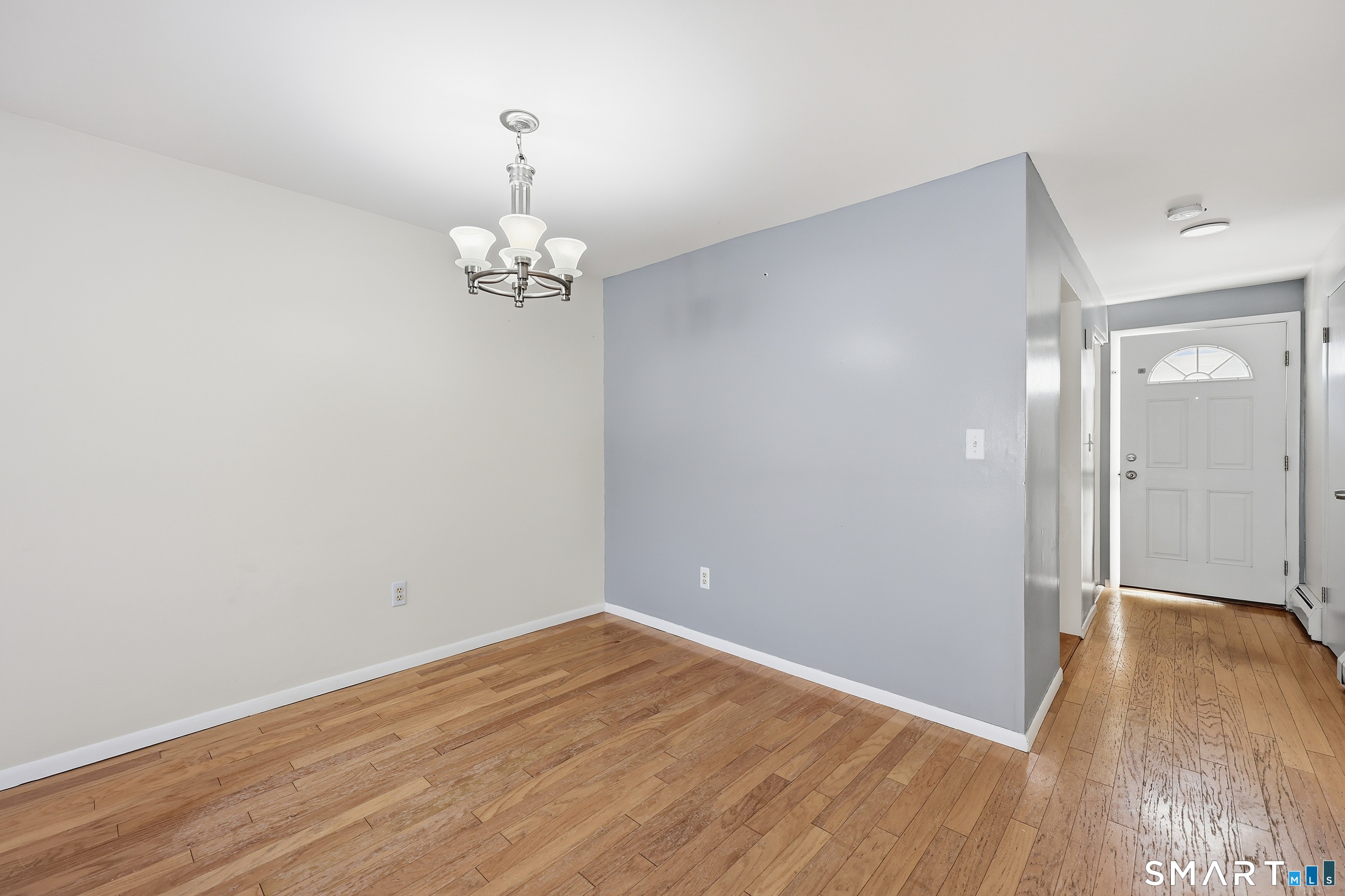 220 Main Street, Unit 2J New Hartford, CT 06057 - Photo 12 of 29 wooden floor in an empty room with a window