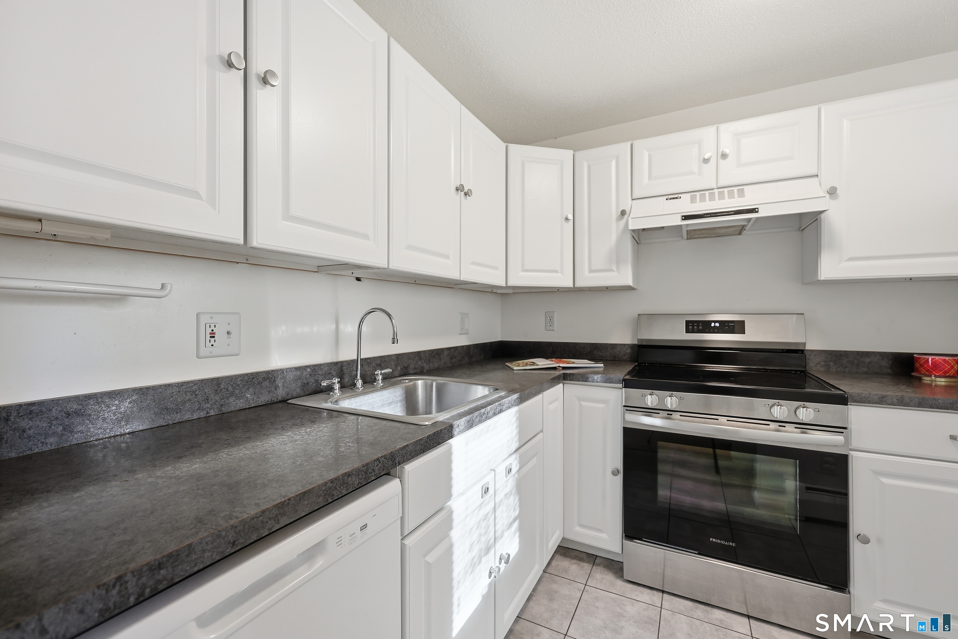 220 Main Street, Unit 2J New Hartford, CT 06057 - Photo 13 of 29 a kitchen with granite countertop white cabinets and stainless steel appliances