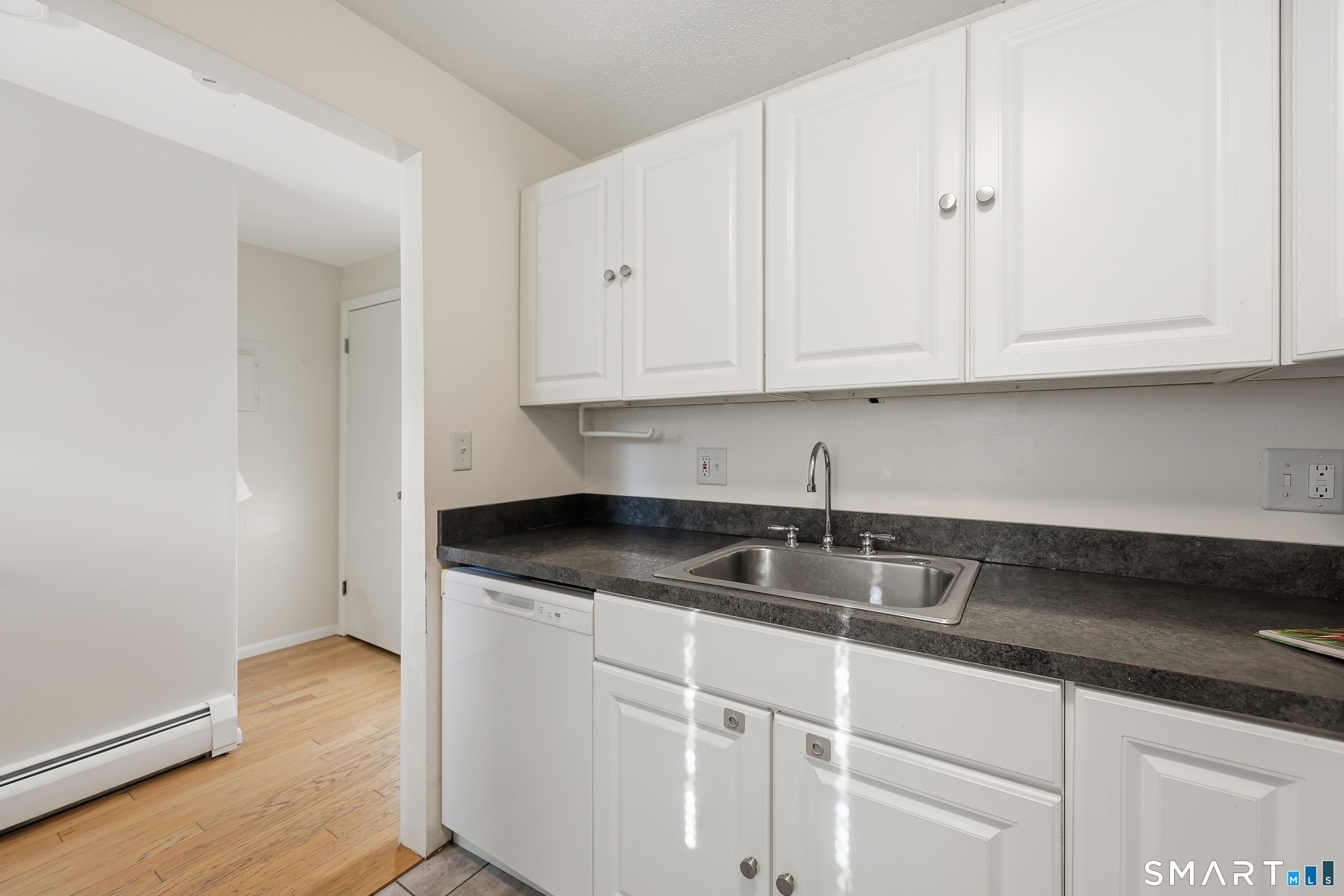 220 Main Street, Unit 2J New Hartford, CT 06057 - Photo 15 of 29 a kitchen with granite countertop white cabinets and a sink