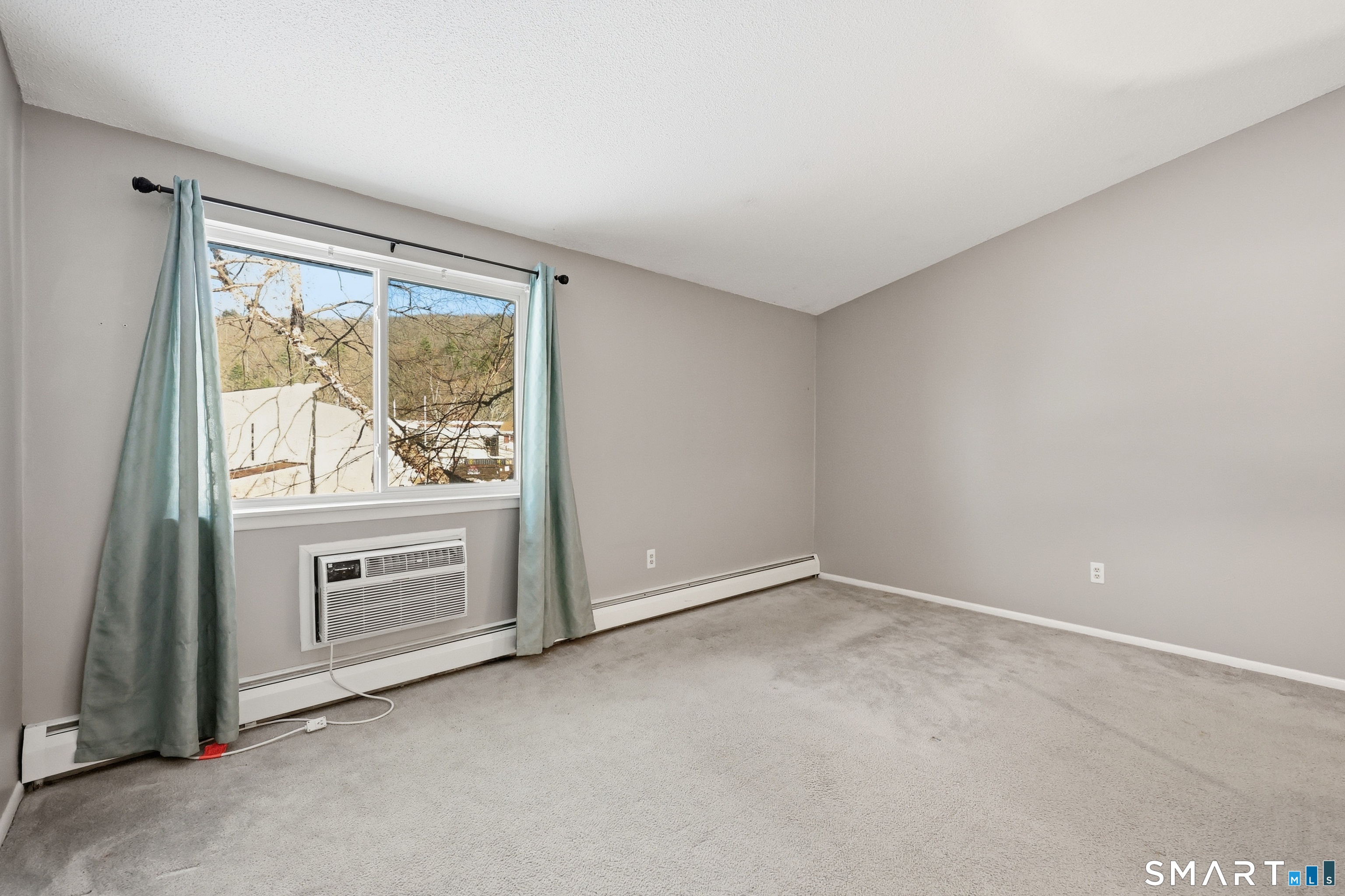 220 Main Street, Unit 2J New Hartford, CT 06057 - Photo 21 of 29 an empty room with closet and windows