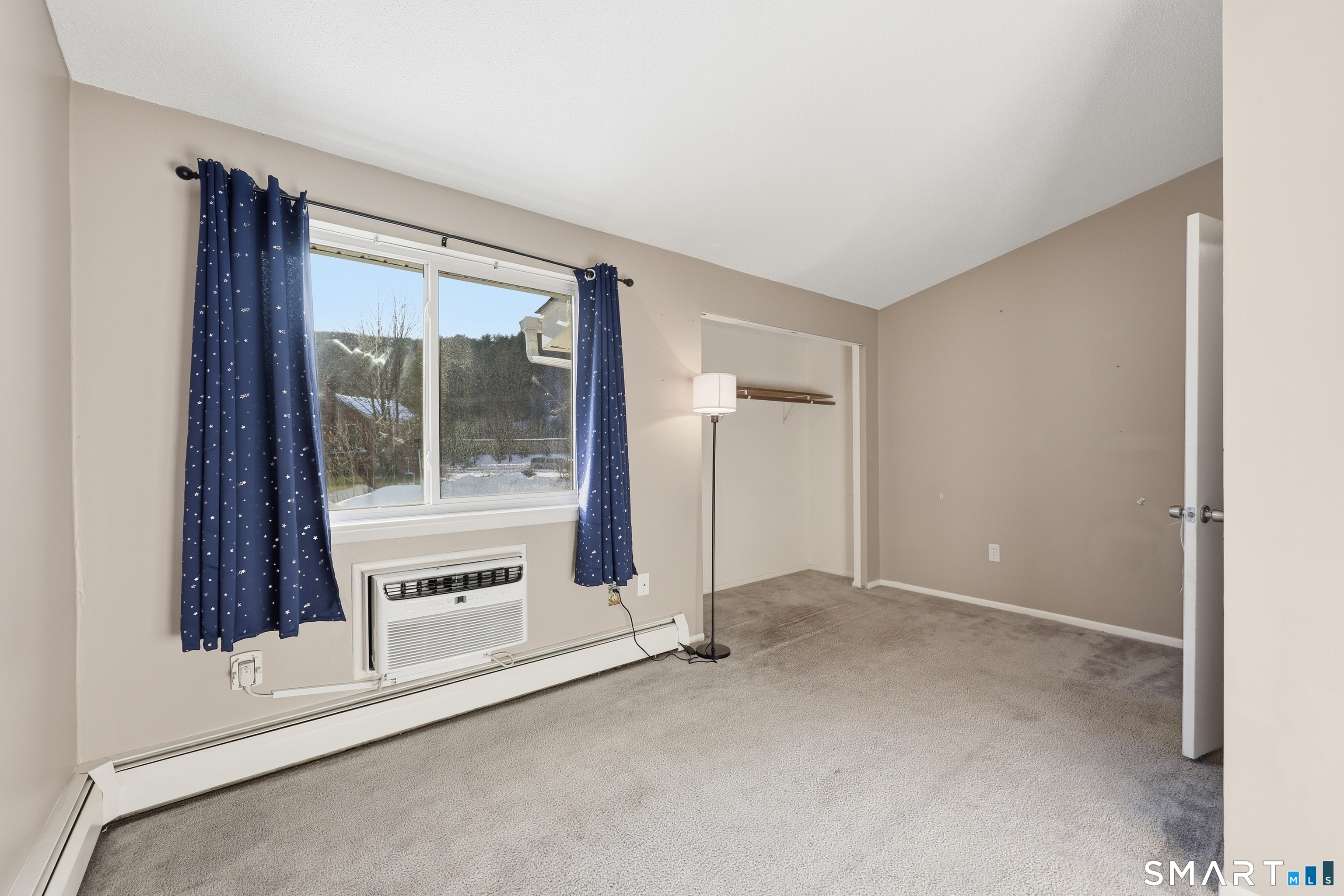 220 Main Street, Unit 2J New Hartford, CT 06057 - Photo 24 of 29 an empty room with a fireplace and windows