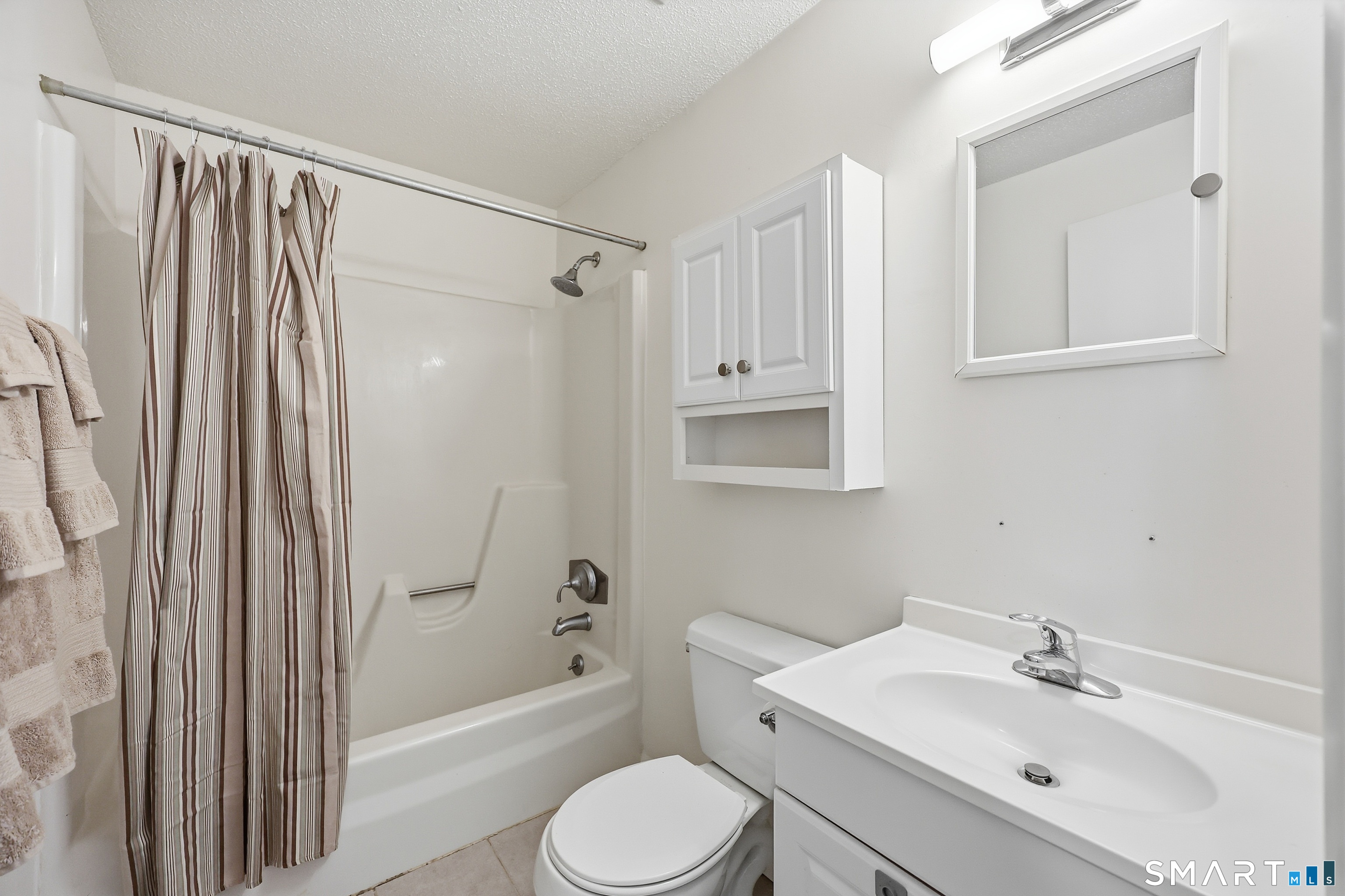 220 Main Street, Unit 2J New Hartford, CT 06057 - Photo 25 of 29 a bathroom with a sink toilet and shower