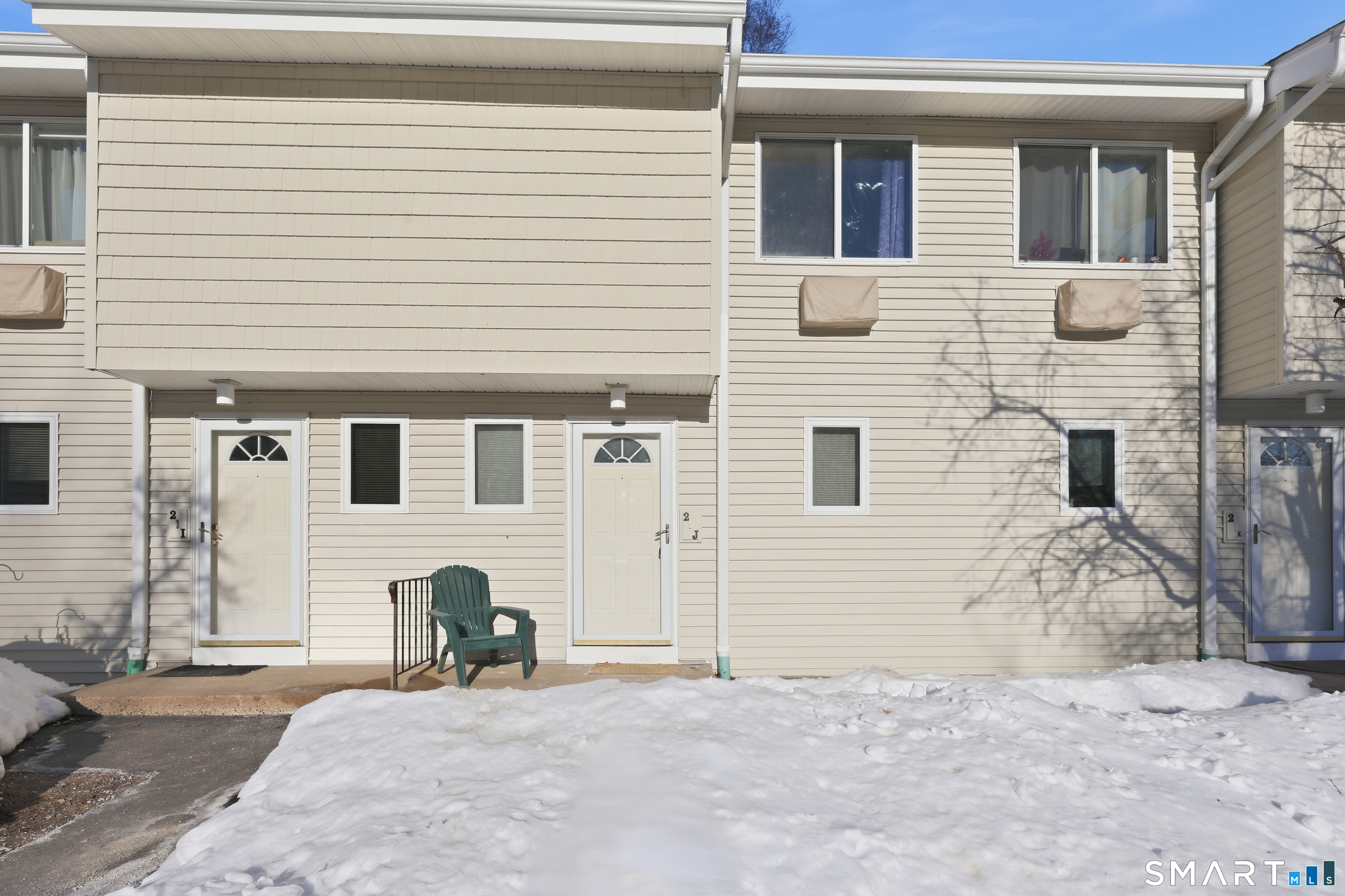 220 Main Street, Unit 2J New Hartford, CT 06057 - Photo 5 of 29 a view of a house with a patio