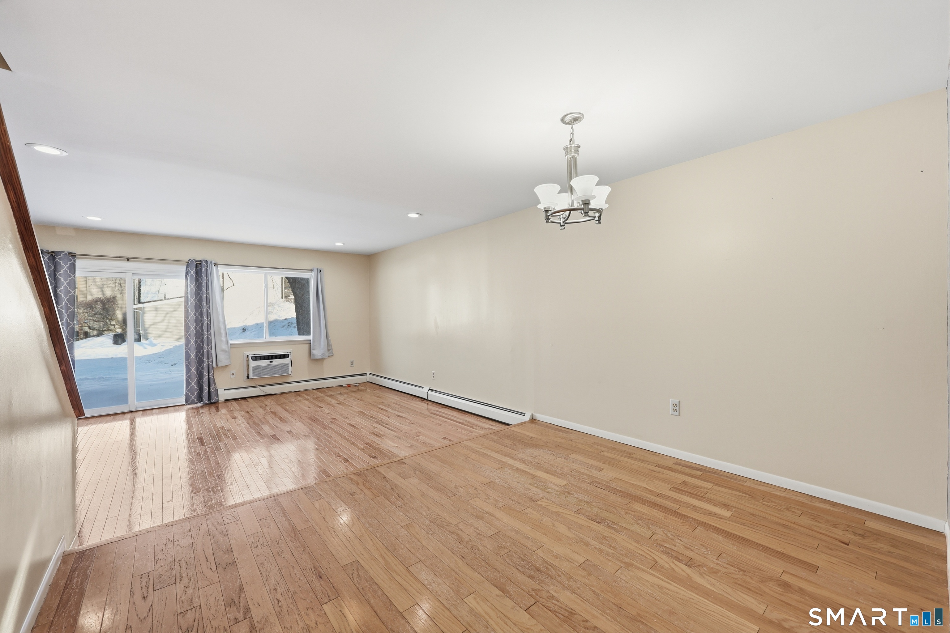 220 Main Street, Unit 2J New Hartford, CT 06057 - Photo 6 of 29 a view of a room with wooden floor and hallway