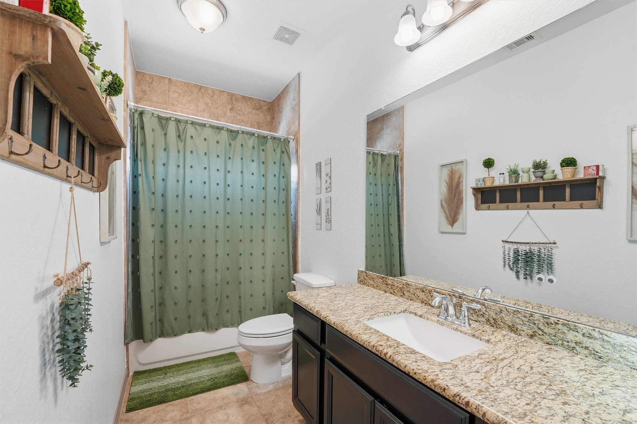 4735 Camp Creek Road Baytown, TX 77523 - Photo 11 of 41 a bathroom with a granite countertop sink a toilet a shower and a mirror