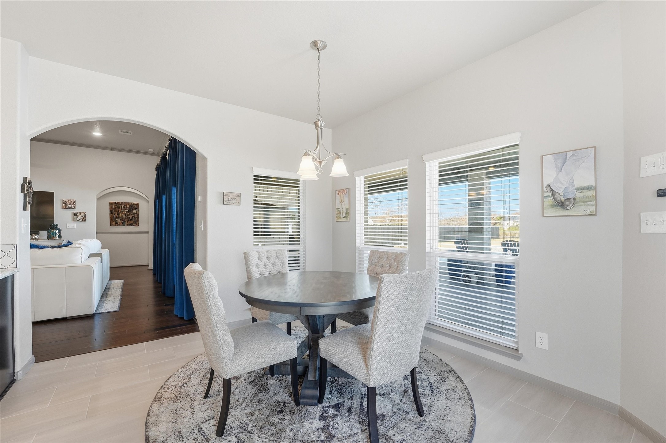 4735 Camp Creek Road Baytown, TX 77523 - Photo 12 of 41 a dining room with furniture a chandelier and wooden floor
