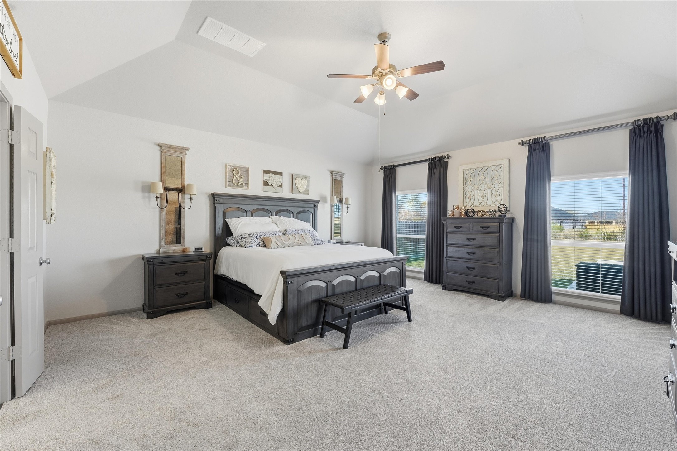 4735 Camp Creek Road Baytown, TX 77523 - Photo 15 of 41 a spacious bedroom with a bed and a chandelier