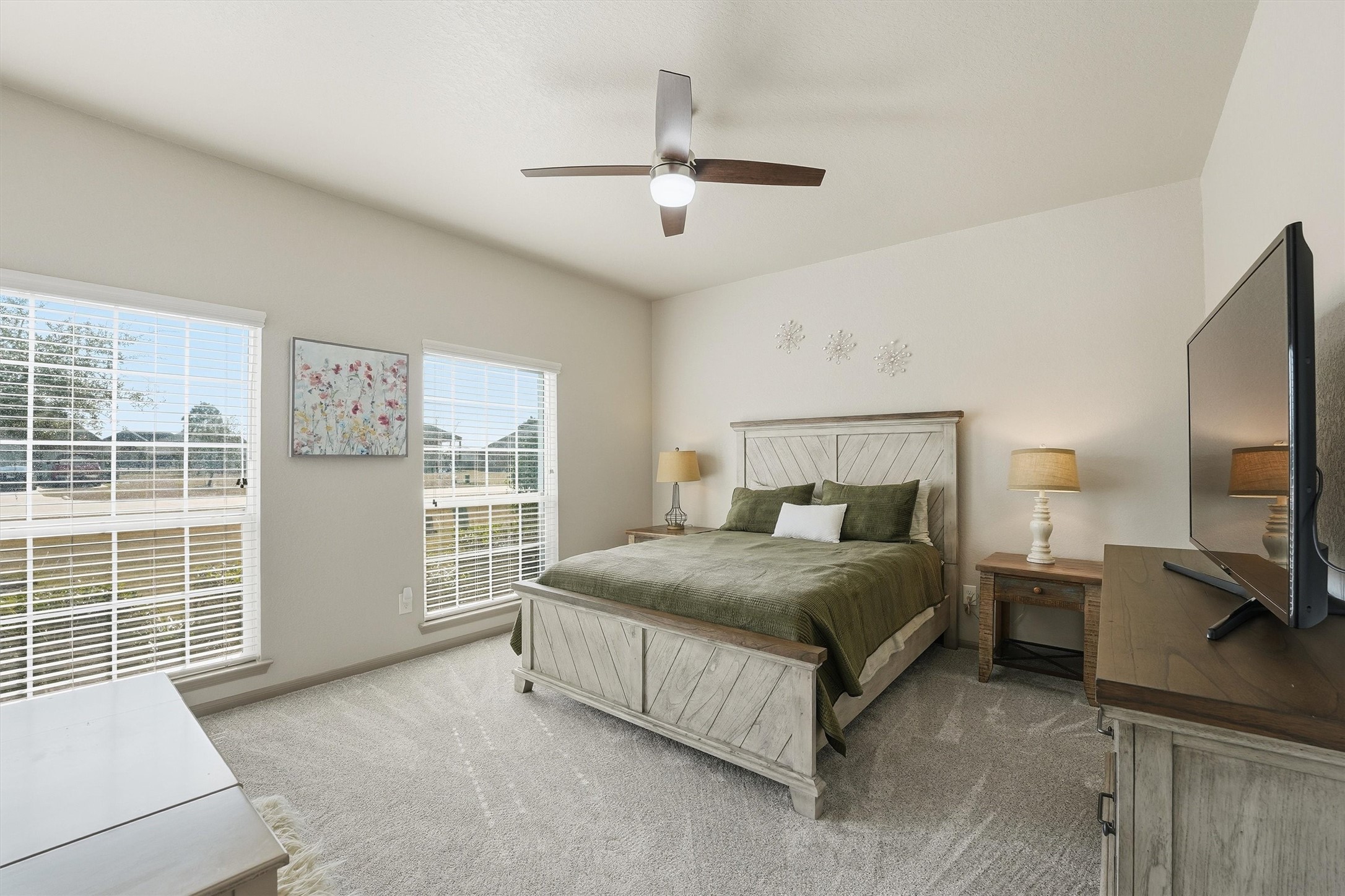 4735 Camp Creek Road Baytown, TX 77523 - Photo 21 of 41 a spacious bedroom with a bed and a flat tv screen on dresser