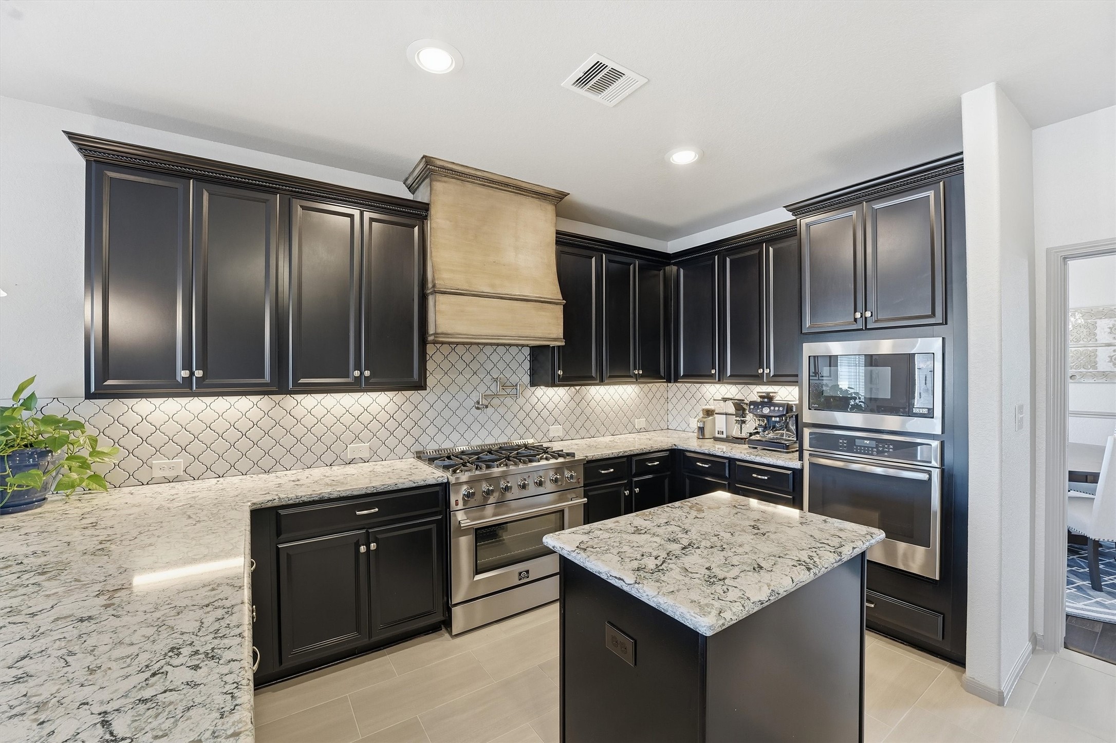 4735 Camp Creek Road Baytown, TX 77523 - Photo 10 of 41 a kitchen with stainless steel appliances granite countertop stove top oven and cabinets
