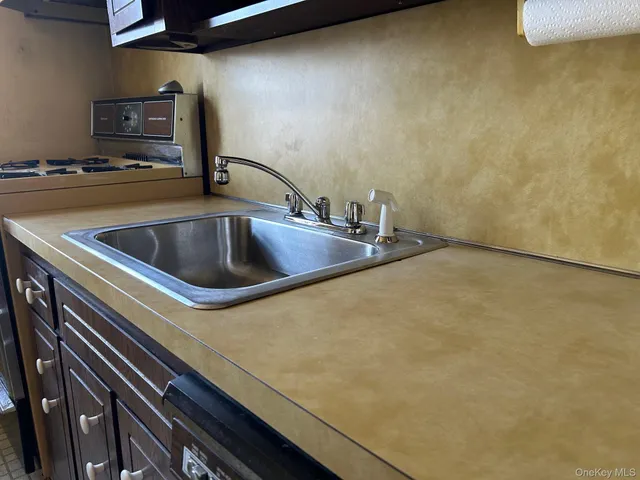 a kitchen with a sink and a stove top oven