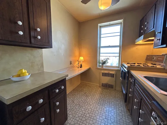 a kitchen with stainless steel appliances a stove a sink and a microwave