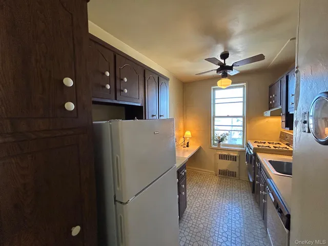 a kitchen with a refrigerator a sink and cabinets