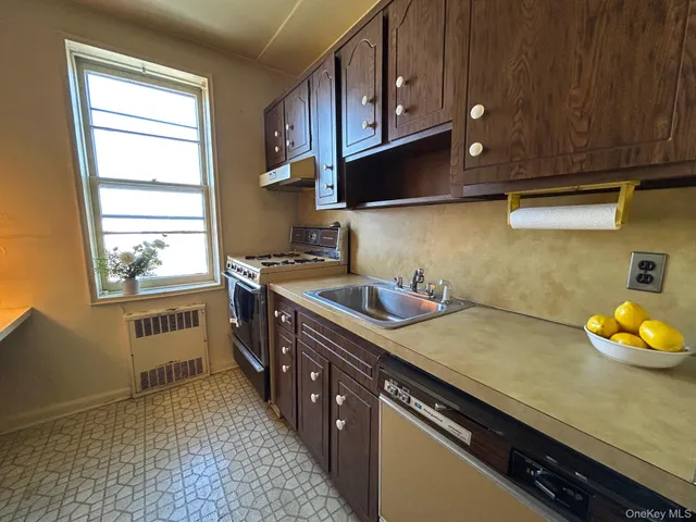 a kitchen with stainless steel appliances a sink stove and cabinets