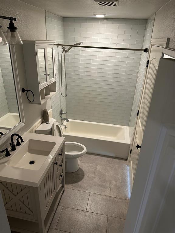 232 Samuel Boulevard, Unit 2 Coppell, TX 75019 - Photo 14 of 19 a bathroom with a sink toilet and shower