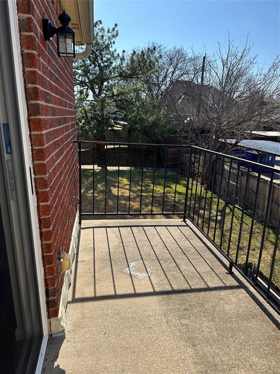 232 Samuel Boulevard, Unit 2 Coppell, TX 75019 - Photo 16 of 19 a view of balcony with wooden floor and fence and potted plants