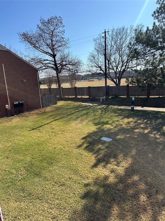 232 Samuel Boulevard, Unit 2 Coppell, TX 75019 - Photo 17 of 19 a view of yard with swimming pool and trees