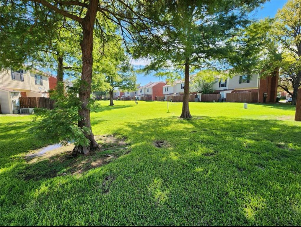 232 Samuel Boulevard, Unit 2 Coppell, TX 75019 - Photo 2 of 19 a swimming pool with trees in the background