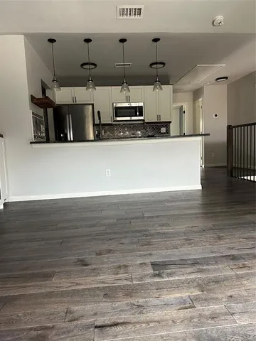 a view of an empty room with a fireplace