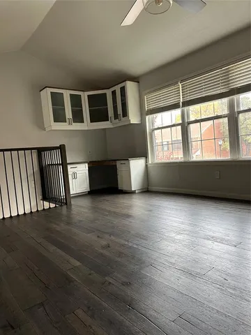 a kitchen with stainless steel appliances a stove a sink and white cabinets