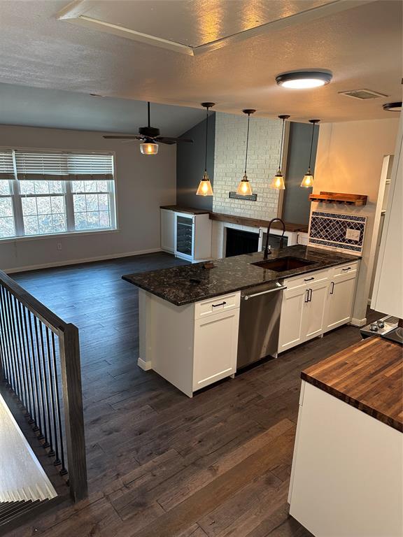 232 Samuel Boulevard, Unit 2 Coppell, TX 75019 - Photo 18 of 19 a kitchen with stainless steel appliances granite countertop a sink a stove and a wooden floors