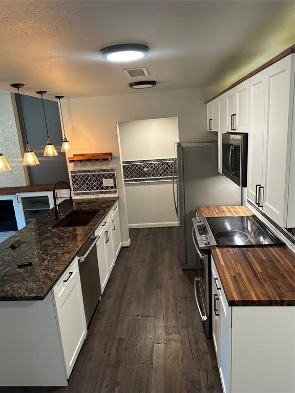 232 Samuel Boulevard, Unit 2 Coppell, TX 75019 - Photo 6 of 19 a kitchen with granite countertop a sink stove and refrigerator