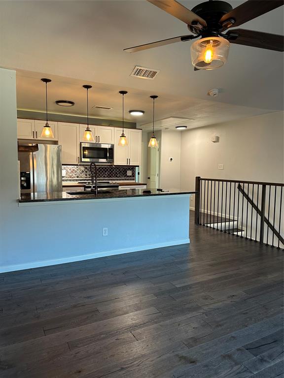 232 Samuel Boulevard, Unit 2 Coppell, TX 75019 - Photo 19 of 19 a view of a living room with kitchen and wooden floor