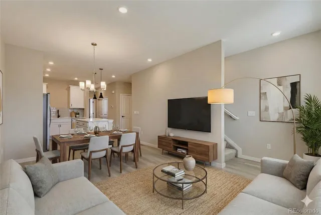 a living room with furniture a flat screen tv and a large window