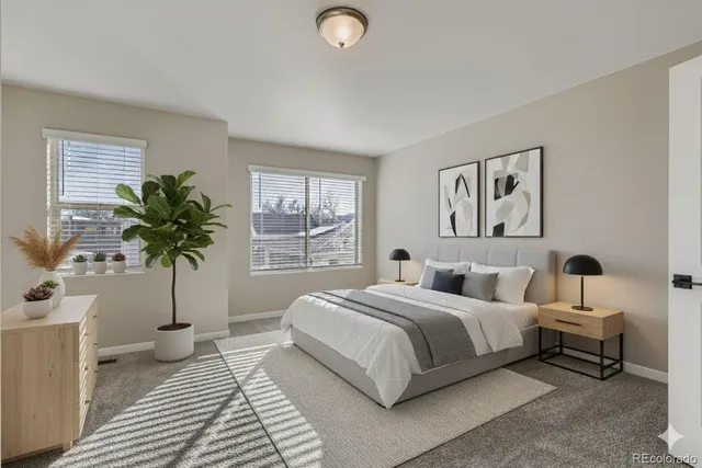 a bedroom with a bed and a potted plant