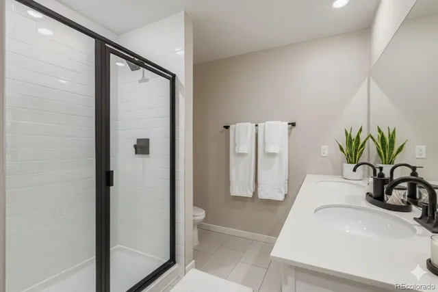 a bathroom with a sink a mirror and a shower